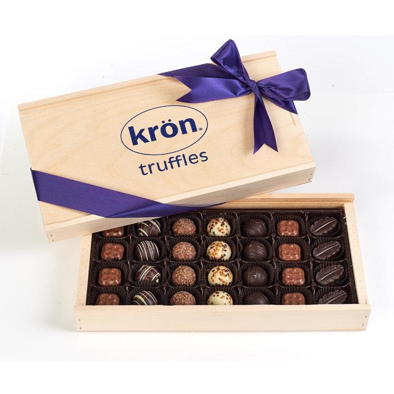 An elegant wooden gift box filled with an assortment of gourmet chocolate truffles, adorned with a deep purple ribbon, perfect for a Thanksgiving gift. The box includes a variety of chocolate flavors and textures, displayed in individual compartments, making it a thoughtful and luxurious treat for the holiday season.